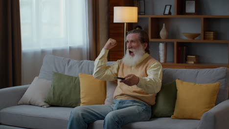 excited senior man watching tv