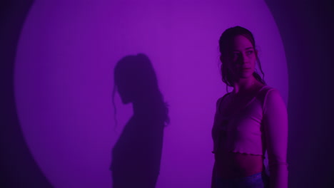 woman in purple lighting with shadow