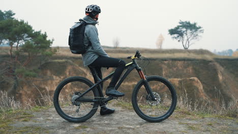 athlete man resting from riding a mountain bike in the hill 1