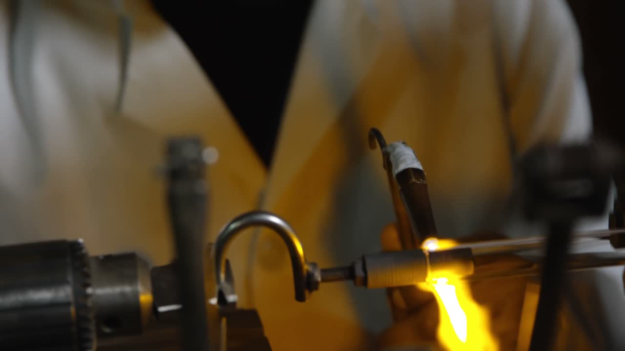 Front view of black female worker creating glass in glass factory 4k