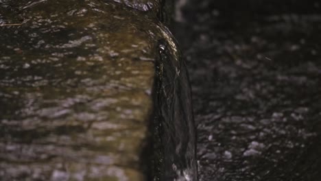 Slow-motion-footage-of-water-streaming-down-the-rocks-in-Devon,-England