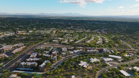 flying over tucson arizona on sunny day, neighborhood of catalina foothills below and bright sky ahead