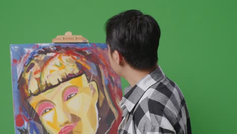 artist looking at abstract painting