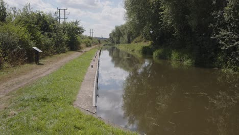 wide shot from aston lock on the trent and mersey canal with towpath