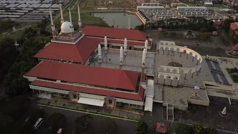 aerial view of the great mosque of central java (majt) in suset time. th sun is orange and the weather is cloudy. view from the side
