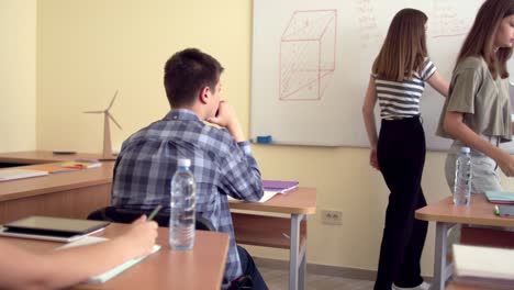 pupils on class in school doing mathematical task on chalkboard