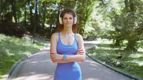 portrait of athletic fit runner girl training looking at camera happy about marathon achievement