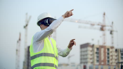 a worker on construction site with vr glasses smart city