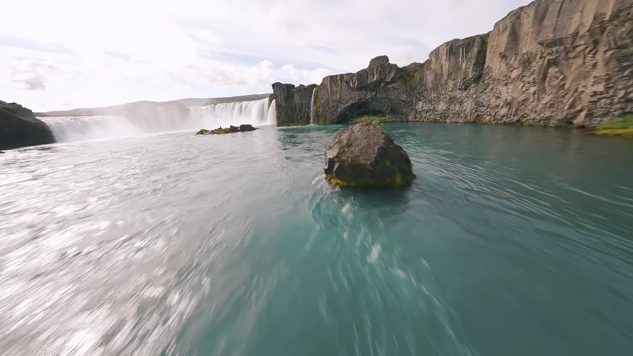 Slow-motion FPV footage capturing the power and beauty of Godafoss waterfall as icy waters cascade dramatically in Iceland