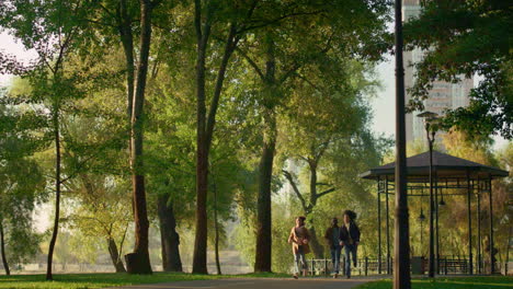 playful girl running park path playing with parents. cheerful childhood moments.