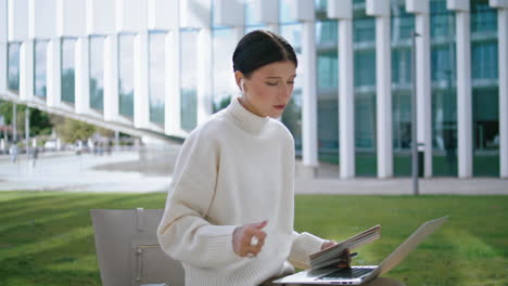 girl talking video conference sitting bench near office close up. coach speaking