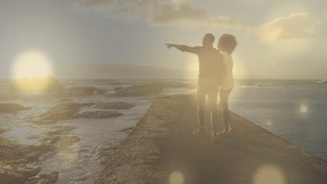 Animation-of-light-spots-over-african-american-couple-walking