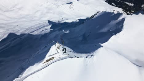 a-drone-flies-over-snow-covered-mountains-in-the-ski-resort