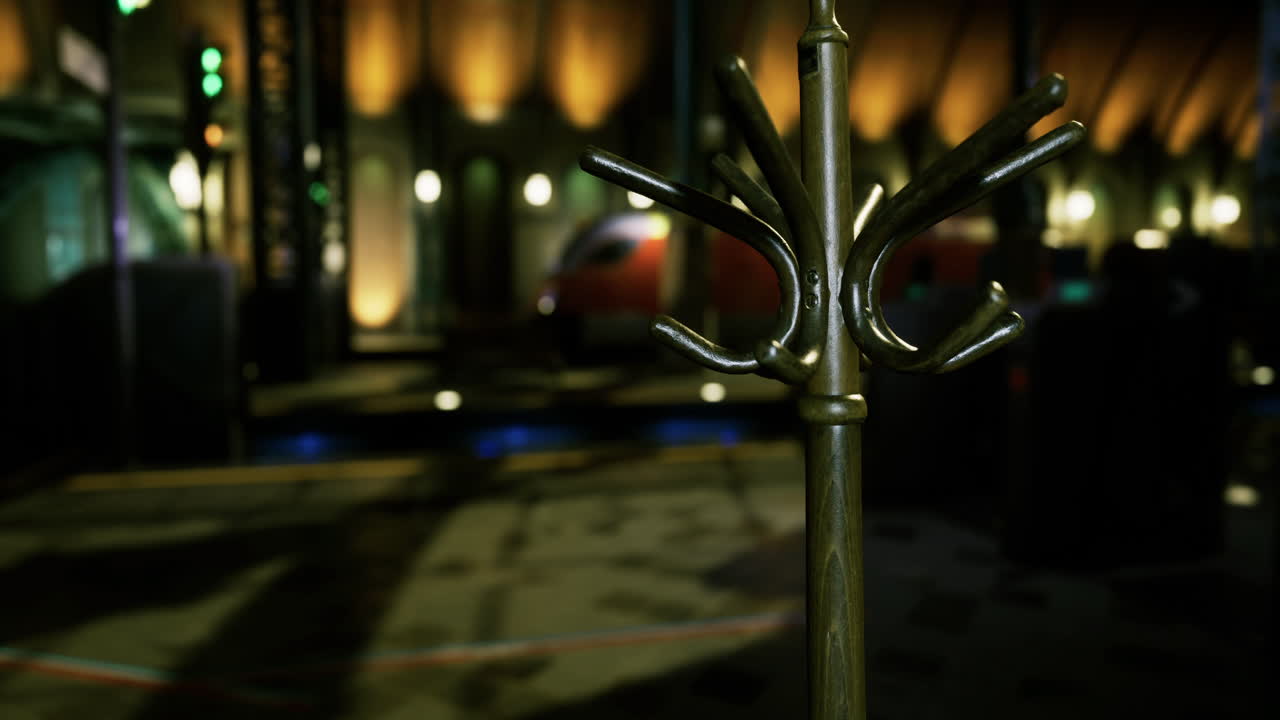 Elegant coat rack stands in a dimly lit venue with warm lighting effects