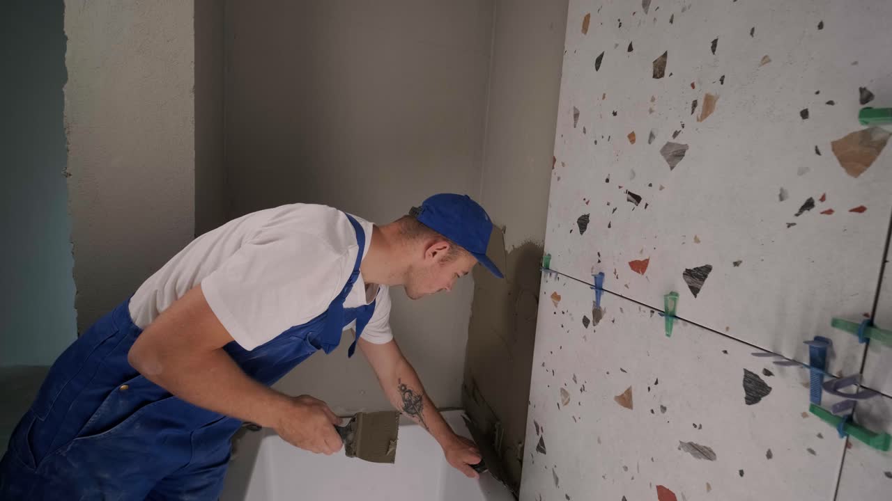Installing ceramic floor tiles - measuring and cutting the pieces. Construction, renovation, repair apartment. Cuts tile. Tile cutting