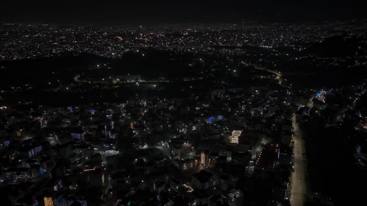 Aerial night drone footage of Kathmandu and Bhaktapur during Diwali (Tihar), glowing with colorful lights, decorations, and candles that highlight Nepal’s festive spirit and cultural celebration