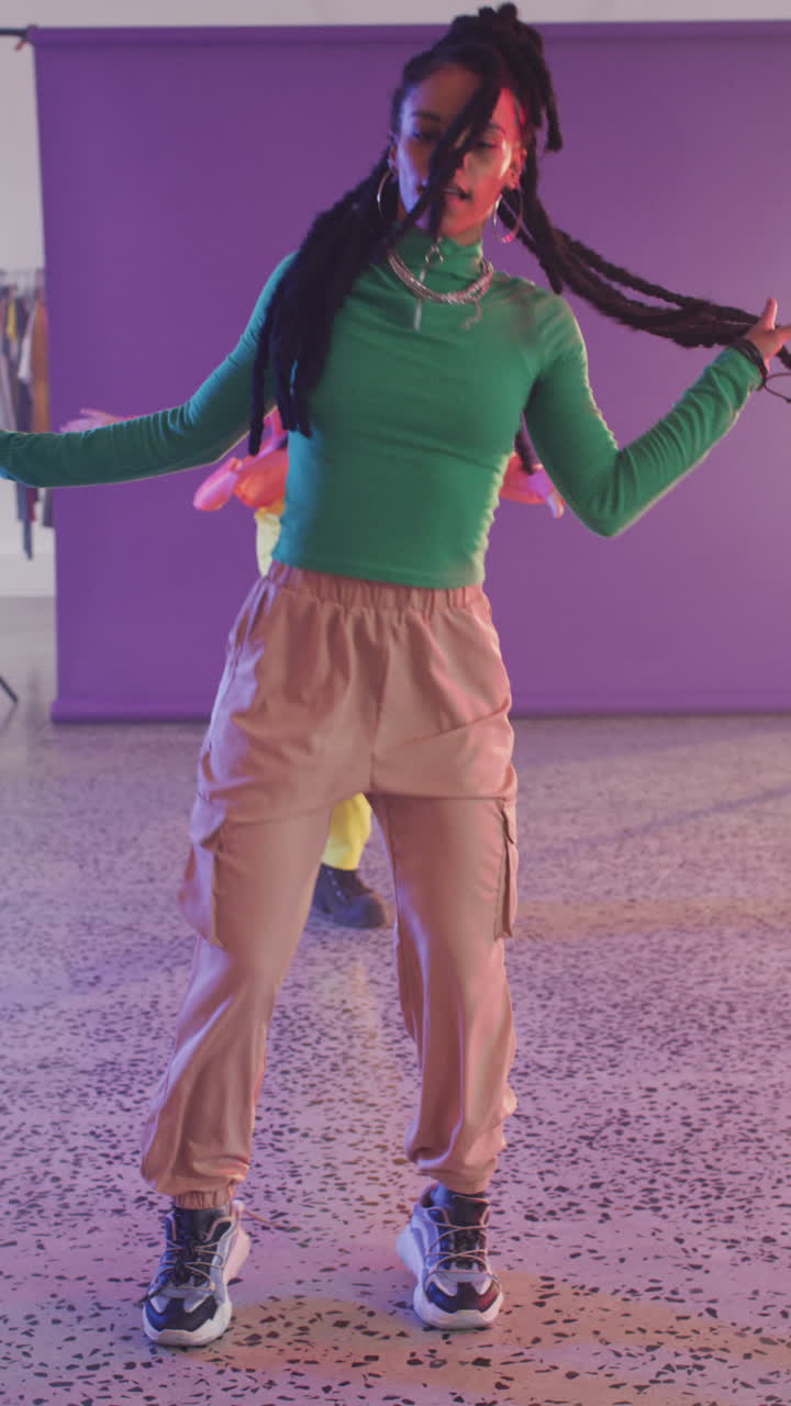 Vertical video of portrait of happy diverse female dancers dancing in dance studio