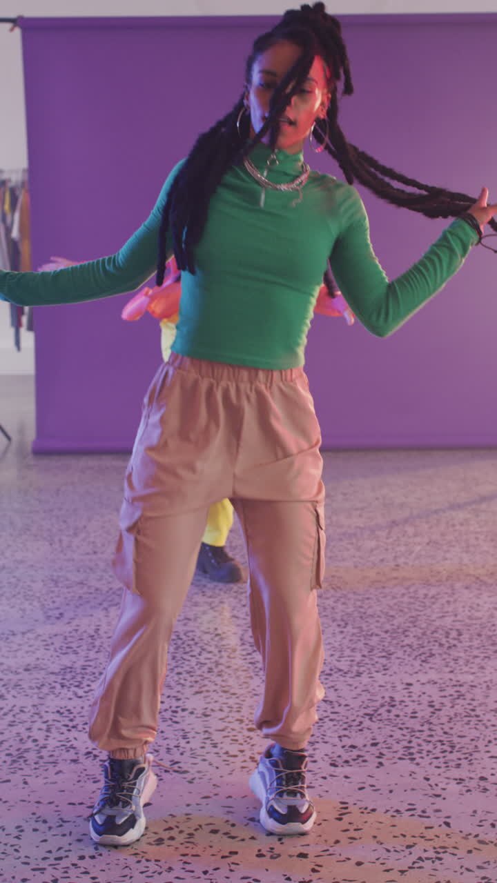 Vertical video of portrait of happy diverse female dancers dancing in dance studio
