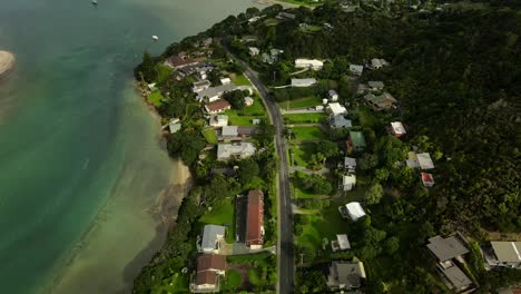 beautiful aerial tilt up to housing area on coast