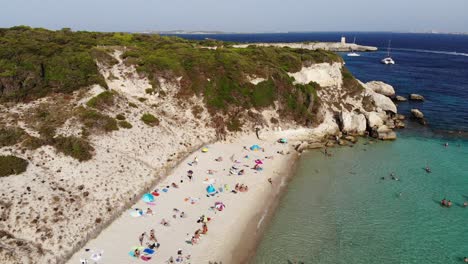 drone flies backward on grande sperone beach in corsica island during a sunny afternoon