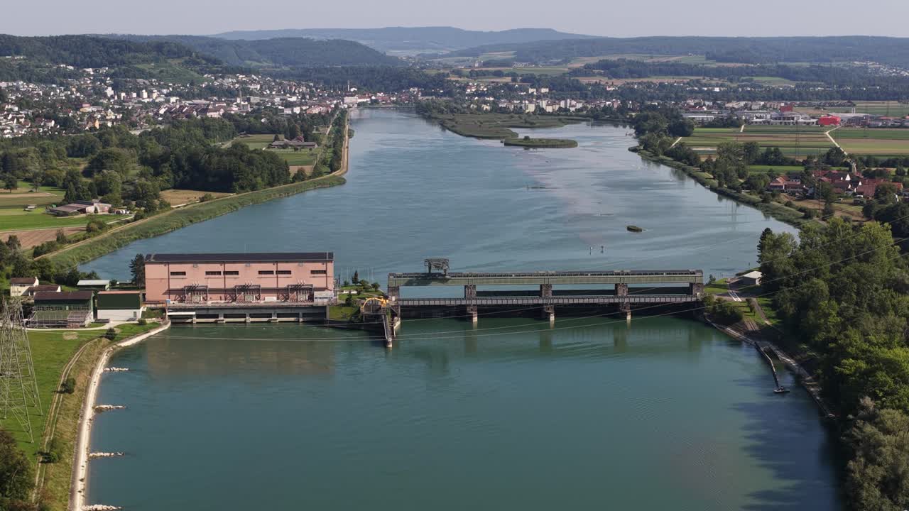 Hydroelectric power plant, electricity from water. River in Switzerland. Clean green energy from nature. Renewable energy resource. Aerial video