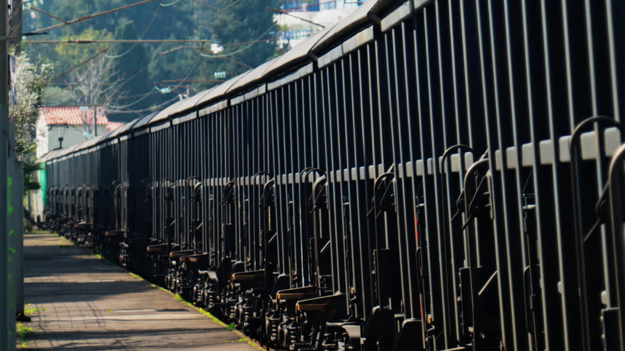 Close up of a grey train moving on the rails in daylight