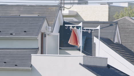 laundry towels hanging on clothesline and billowing by wind