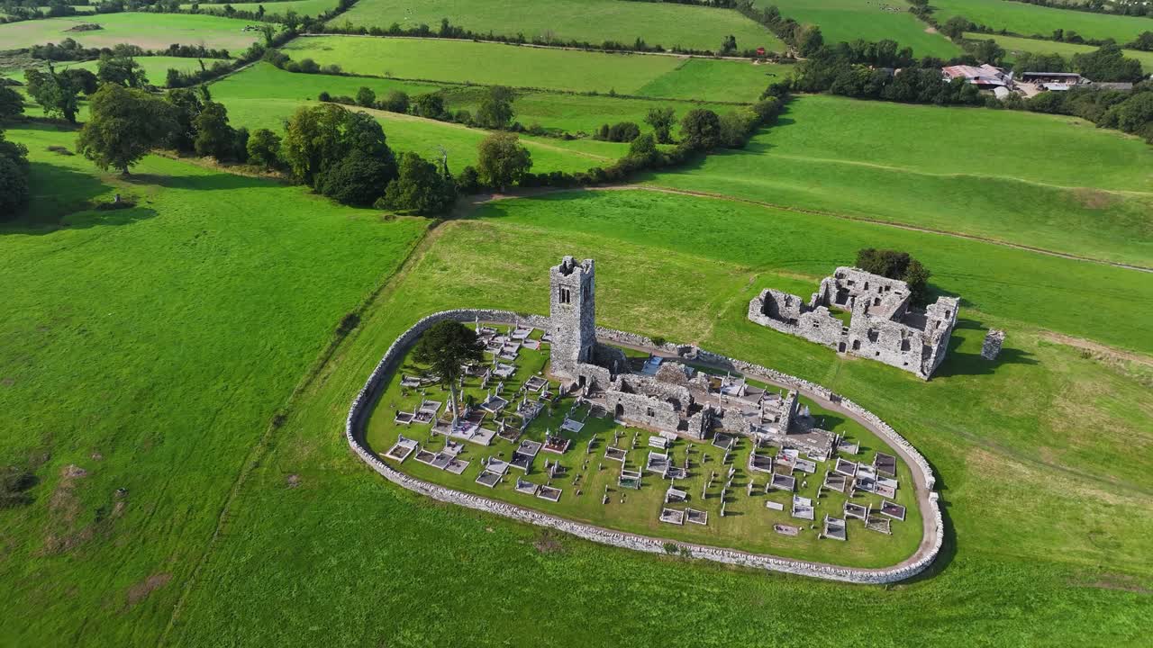 Drone reveal of Slane Abbey old church with graveyard on Hill of Slane, Co. Meath Ireland