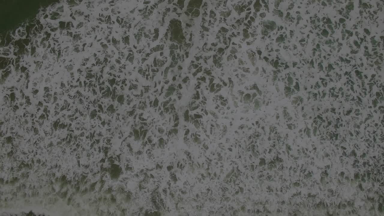 System activating, green terminal overlay fading over surf, panels populating and showing metrics