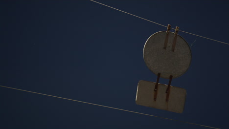 Closeup-warning-road-sign-at-night-hanging-on-wires-above-highway-rear-view.