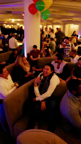 people enjoying drinks and conversation at a social event