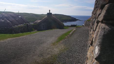 static shot of the road running through the gearrannan blackhouse village, a museum and recreation of a historic, scottish blackhouse township