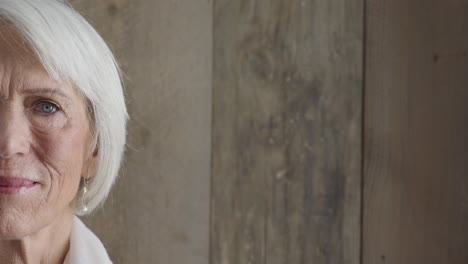 portrait-of-beautiful-middle-aged-woman-looking-serious-at-camera-pretty-blue-eyes-half-face-close-up