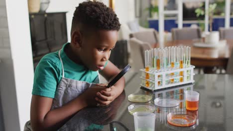 Video-of-african-american-boy-with-magnifier-doing-experiments-at-home