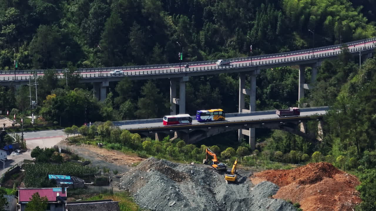 Telephoto drone shot tracking buses on a elevated road, sunny day in China