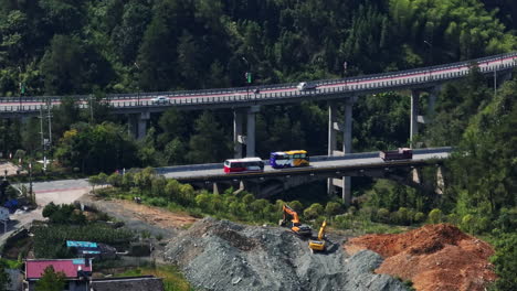 telephoto drone shot tracking buses on a elevated road, sunny day in china
