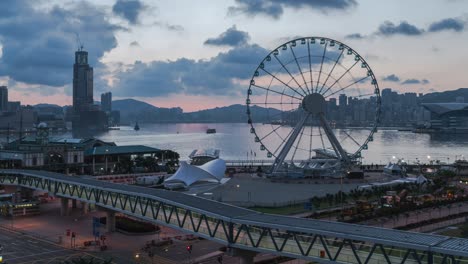 large ferris wheel at sunrise in hong kong city.