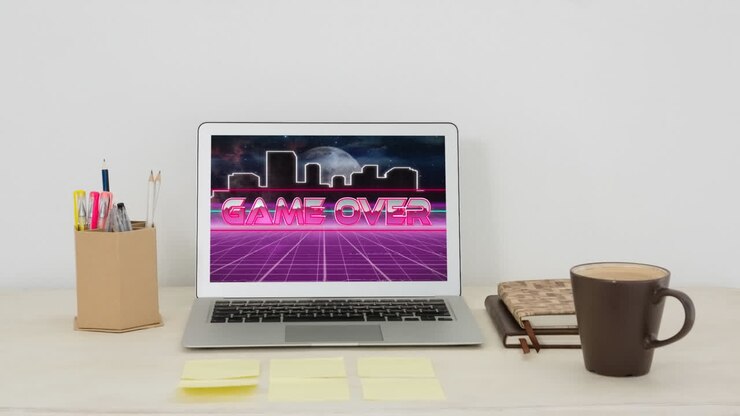 Animation of game over text on laptop screen on desk