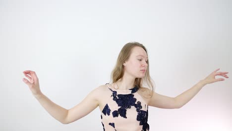 beautiful young woman in pink floral dress posing in studio