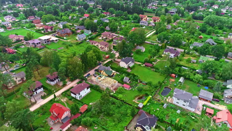 drone flyover building construction site in the middle of a rural village