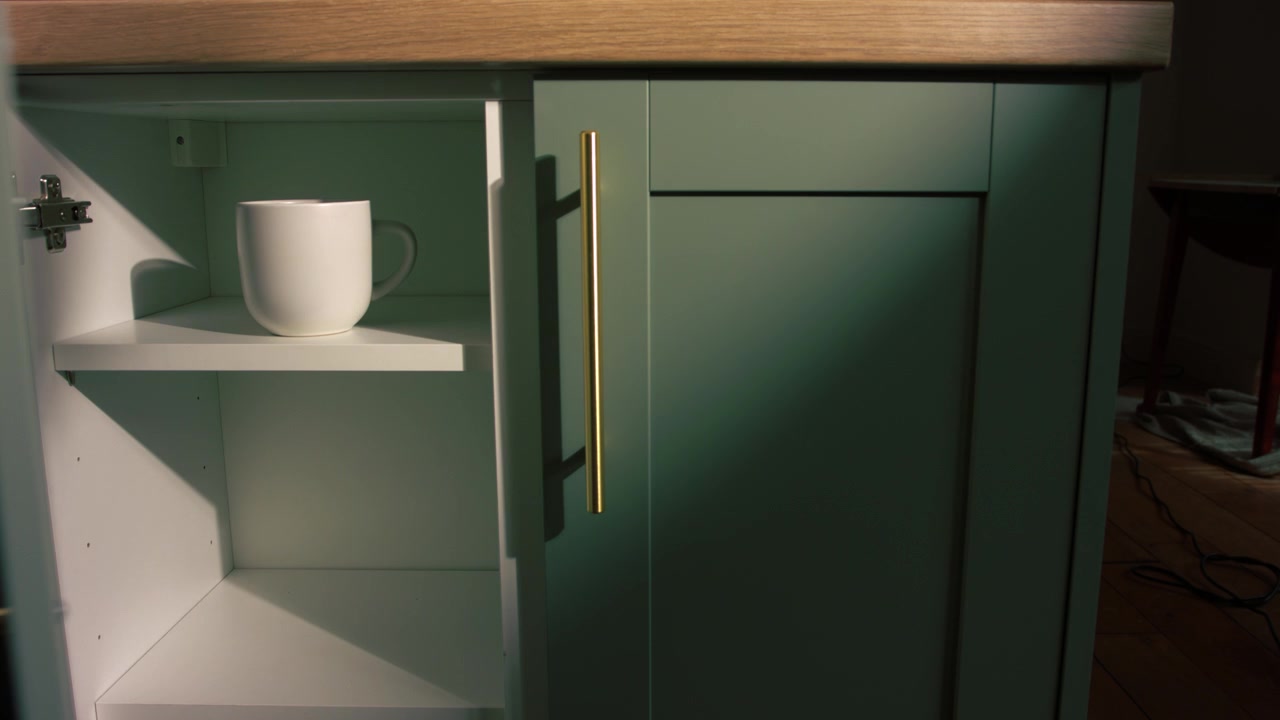 Hand opens kitchen cupboard to get a medium mug shot 4k selective focus