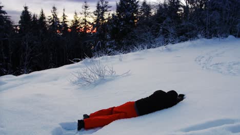 man relaxing in snow 4k