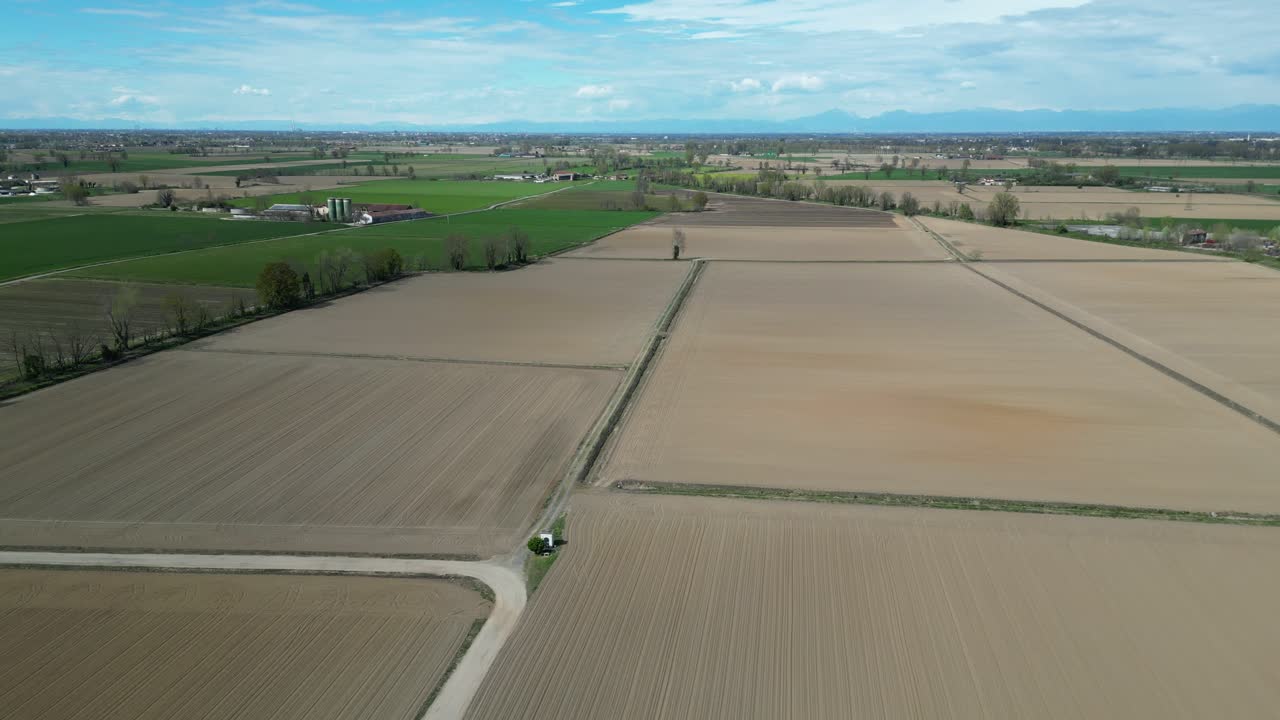 Freshly cultivated corn fields in the Po Valley in Italy, with the Alps in the background