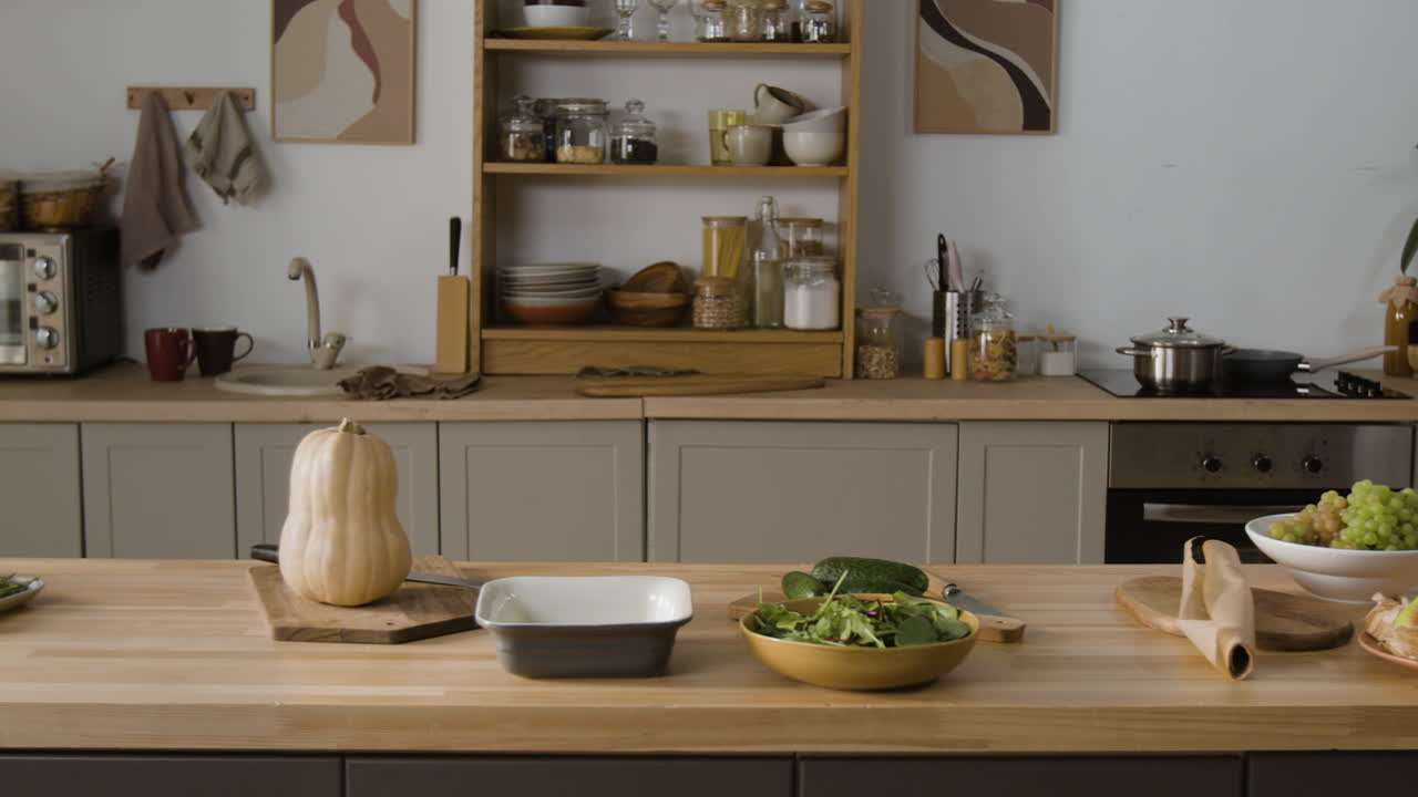 Kitchen scene with vegetables and cooking utensils on the counter