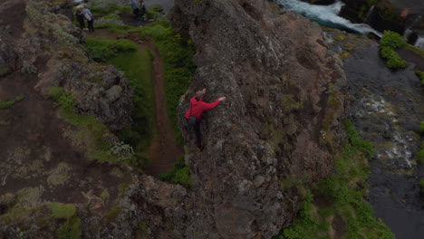 Aerial-view-orbit-man-hiking-peak-adventurous-in-Iceland-wild-countryside.-Drone-view-man-hiker-climbing-high-peak-in-icelandic-highlands-exploring-wilderness