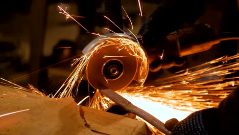 blacksmith sawing metal with hand circular saw