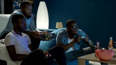 black man having fun with videogame at home