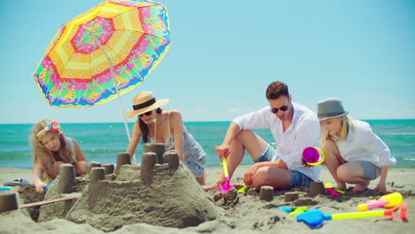 family building sandcastles on the beach