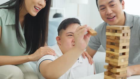 family playing wooden blocks game