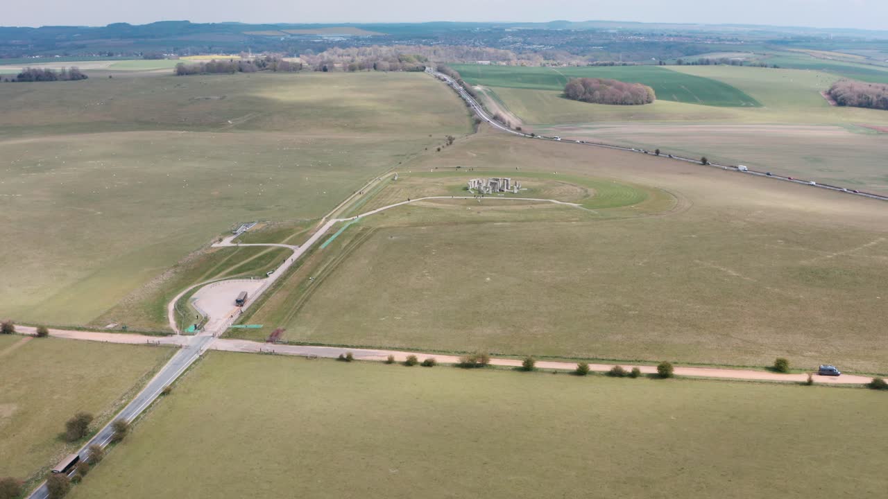 Dolly forward drone shot of Stonehenge towards A303 highway
